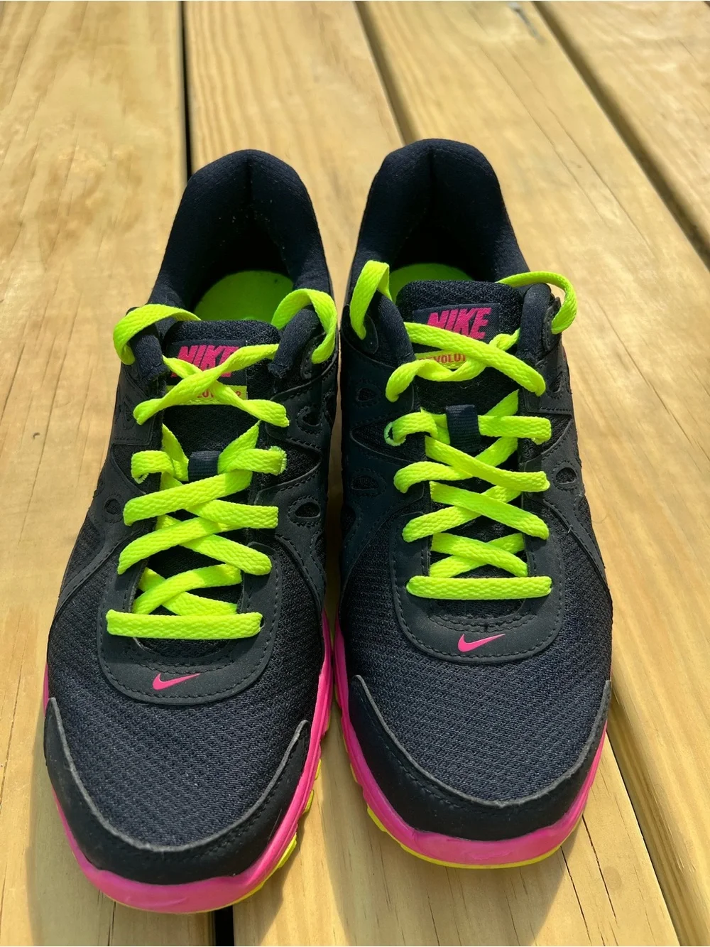 Nike Women’s navy Sneakers with Hot Pink & Neon Yellow Accents.Nike Revolution 2